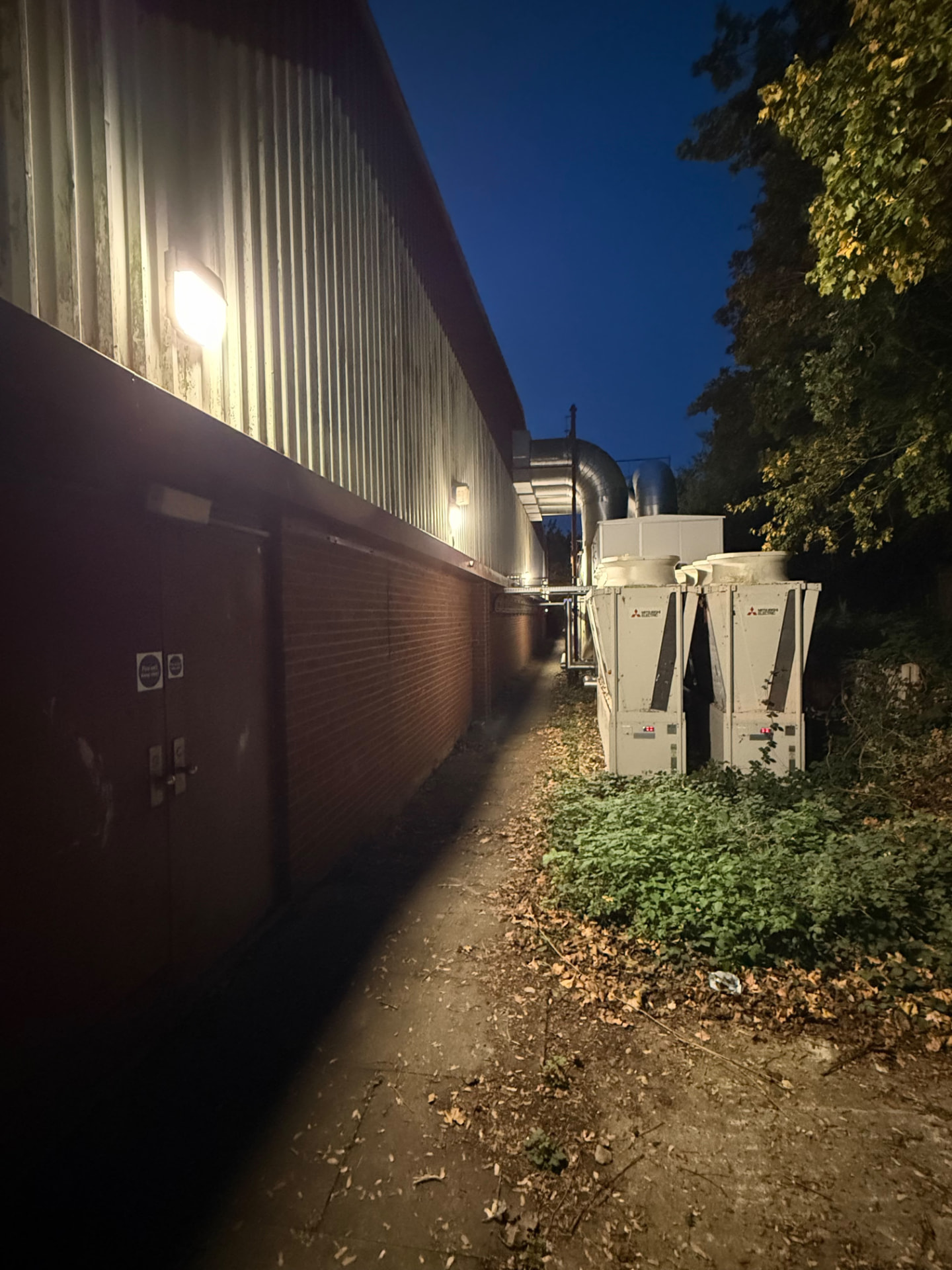 external LED wall lighting on a leisure centre at night, light beside external plant